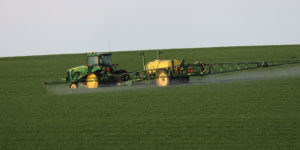 Grower spraying Aggressor AX herbicide